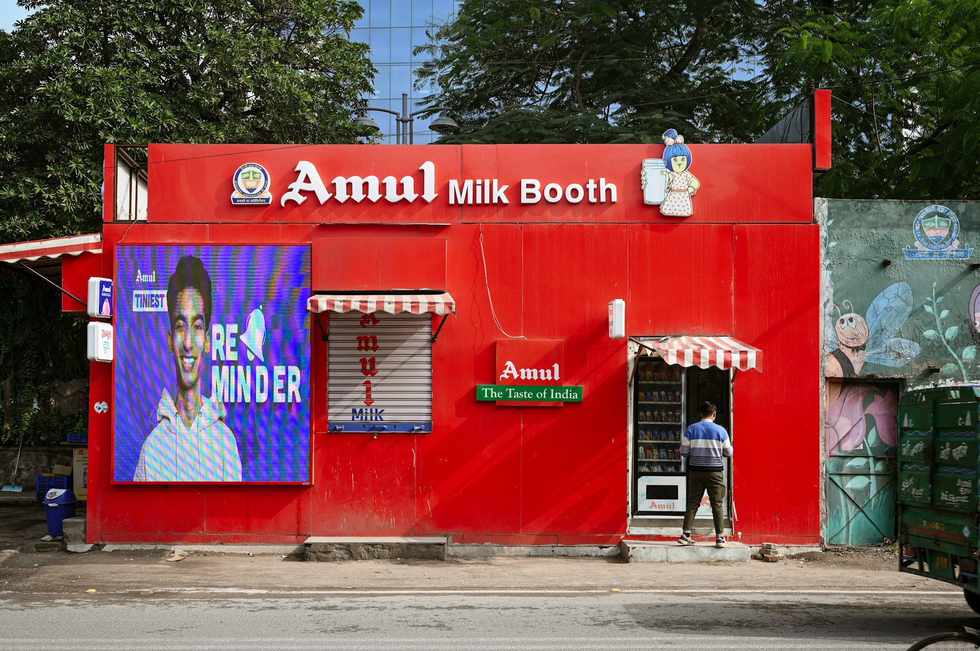 An amul milk booth stands bright red in india.